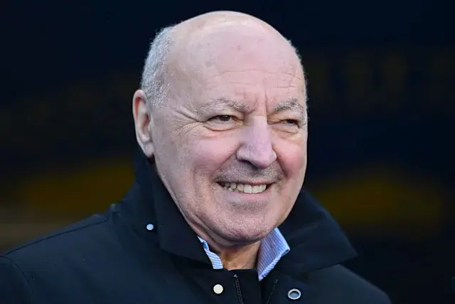 Close-up portrait of Beppe Marotta smiling, wearing a black jacket