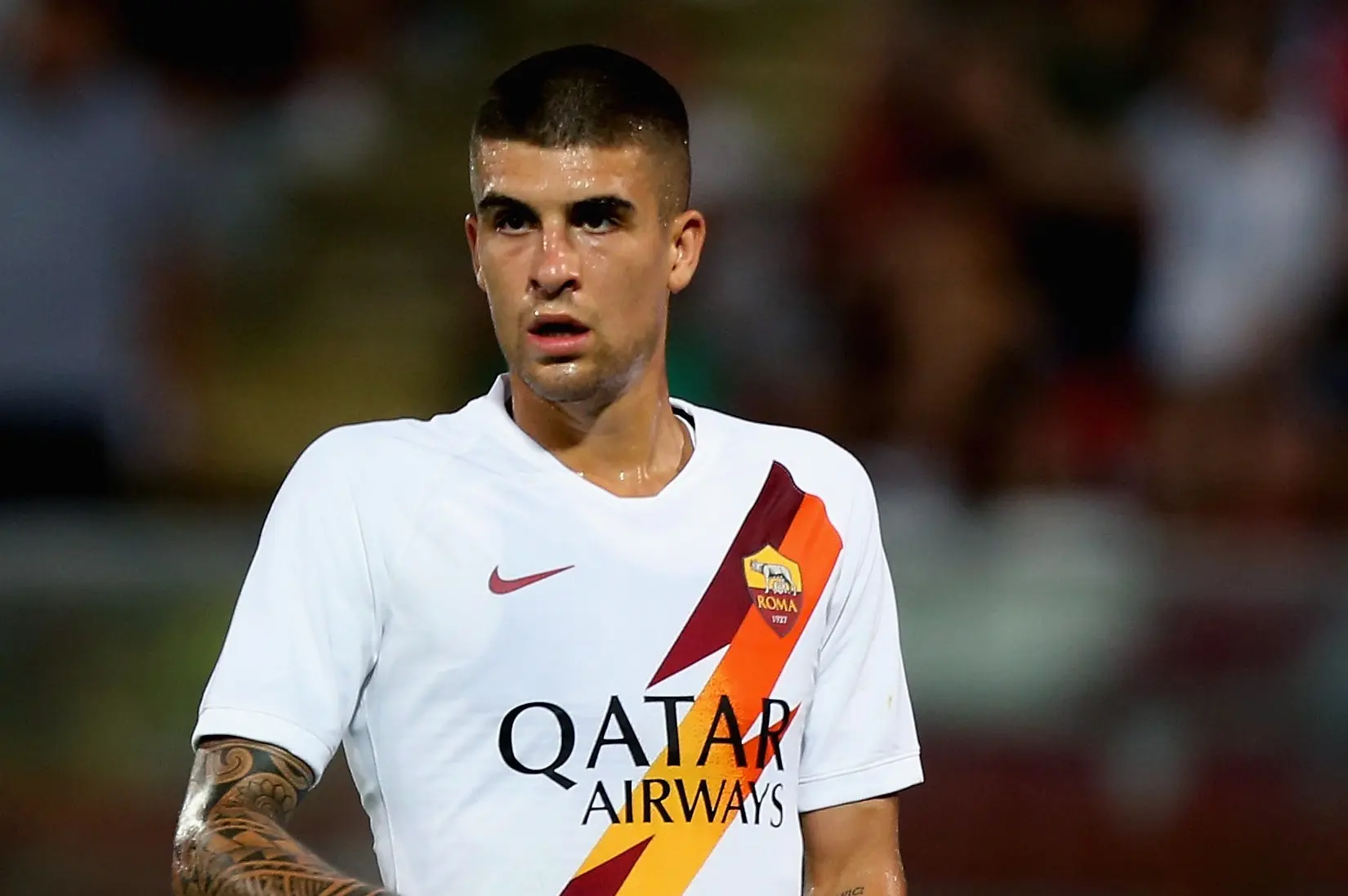 Gianluca Mancini in a Roma jersey during a soccer match.