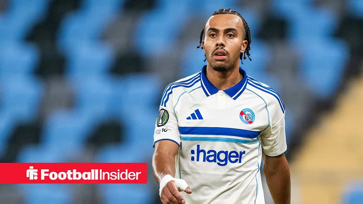 Strasbourg defender wearing a white football jersey with blue stripes on the field.