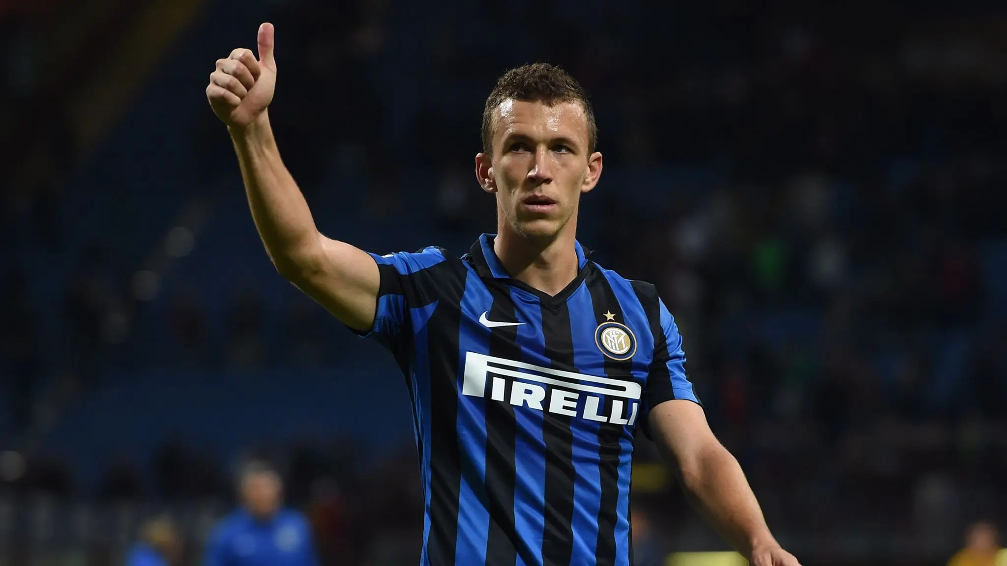 Ivan Perisic wearing an Inter Milan home kit and giving a thumbs up during a match
