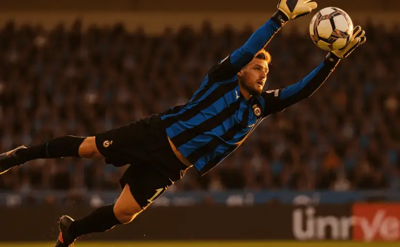 Inter Milan goalkeeper making dramatic diving save at San Siro stadium in black and blue striped jersey