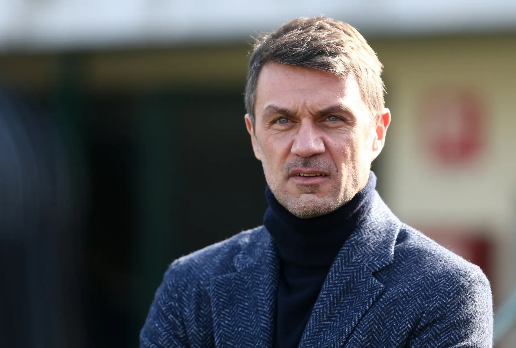 Close-up portrait of Paolo Maldini wearing a navy turtleneck and a grey herringbone blazer.