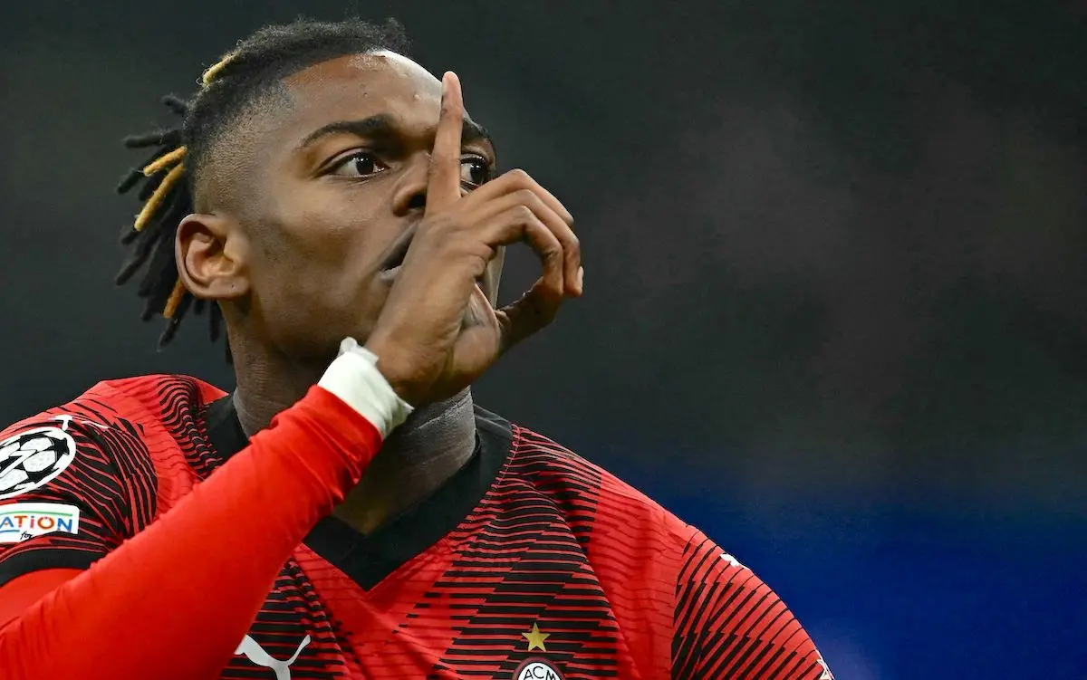 Rafael Leao in an AC Milan kit making a gesture with his hand during a match