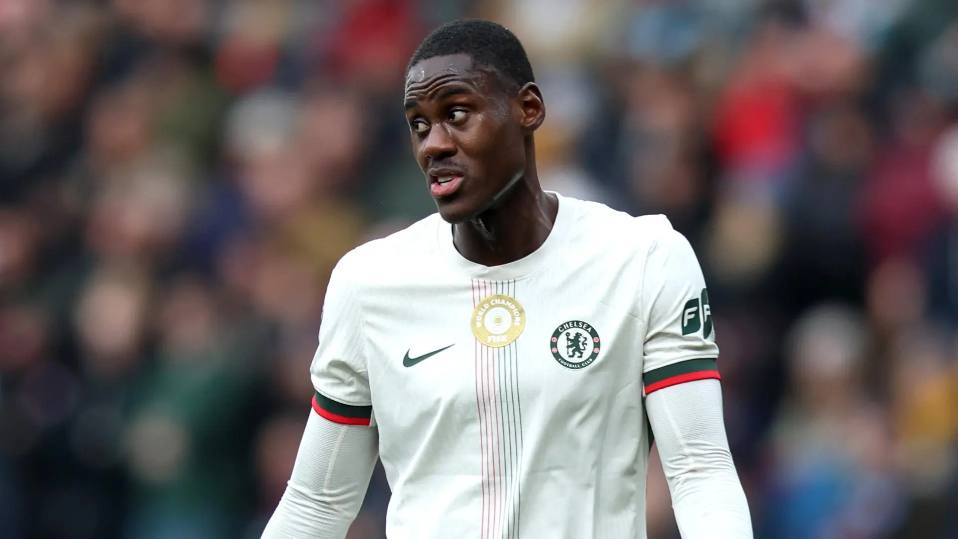 Trevoh Chalobah in a Chelsea jersey during a match, showing his expression.