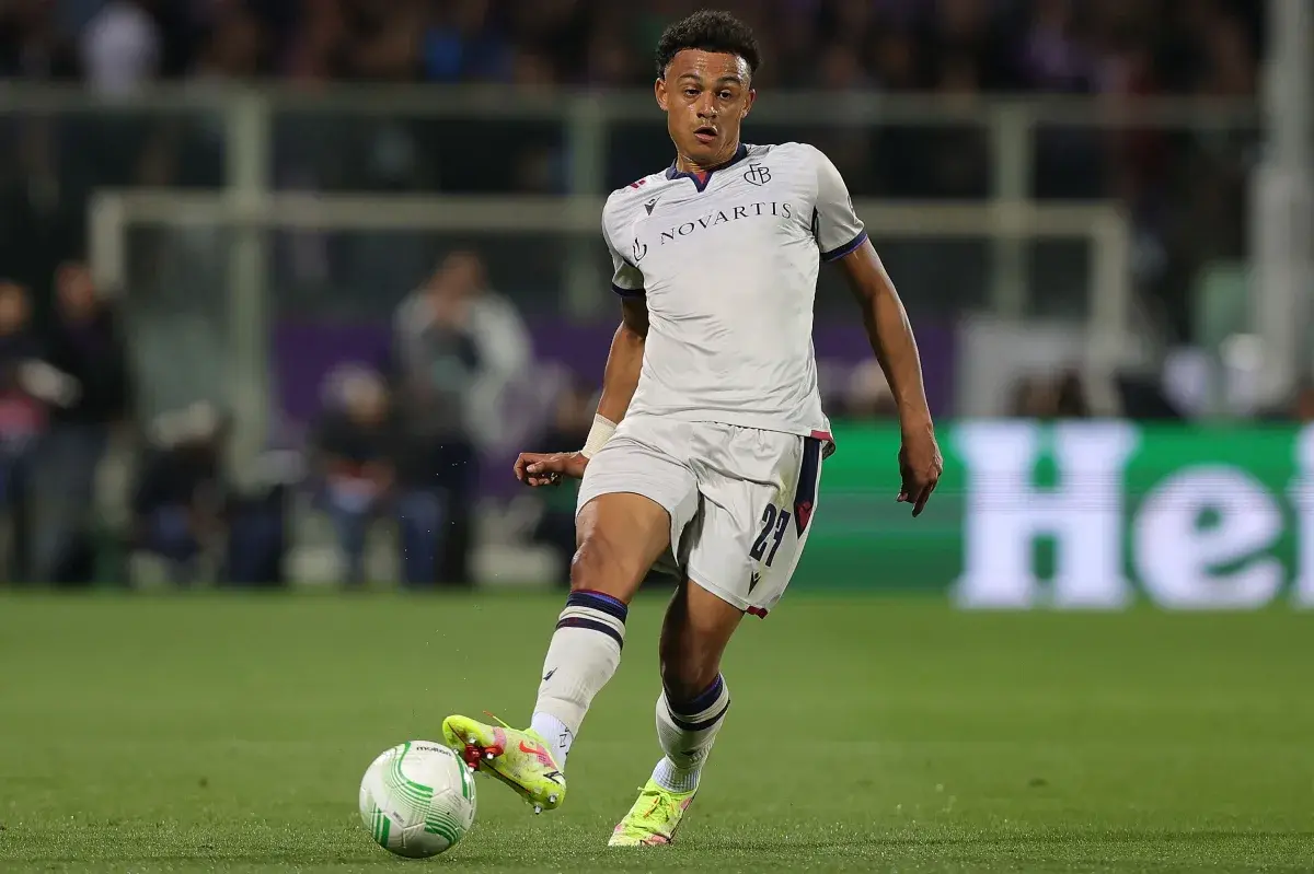 Andy Diouf in a white FC Basel kit dribbling a soccer ball during a match