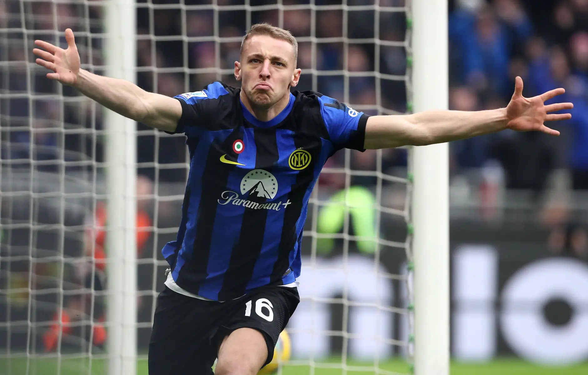Davide Frattesi celebrating in an Inter Milan home kit during a football match