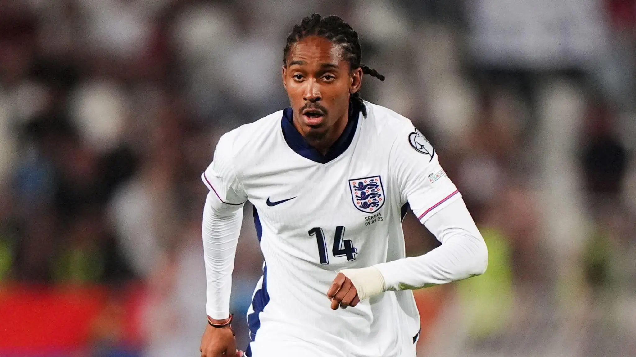 Djed Spence wearing the England national team white football kit with number 14