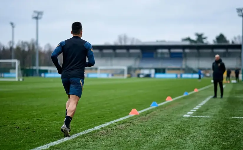 Footballer completing an individual training drill during a cautious return from injury