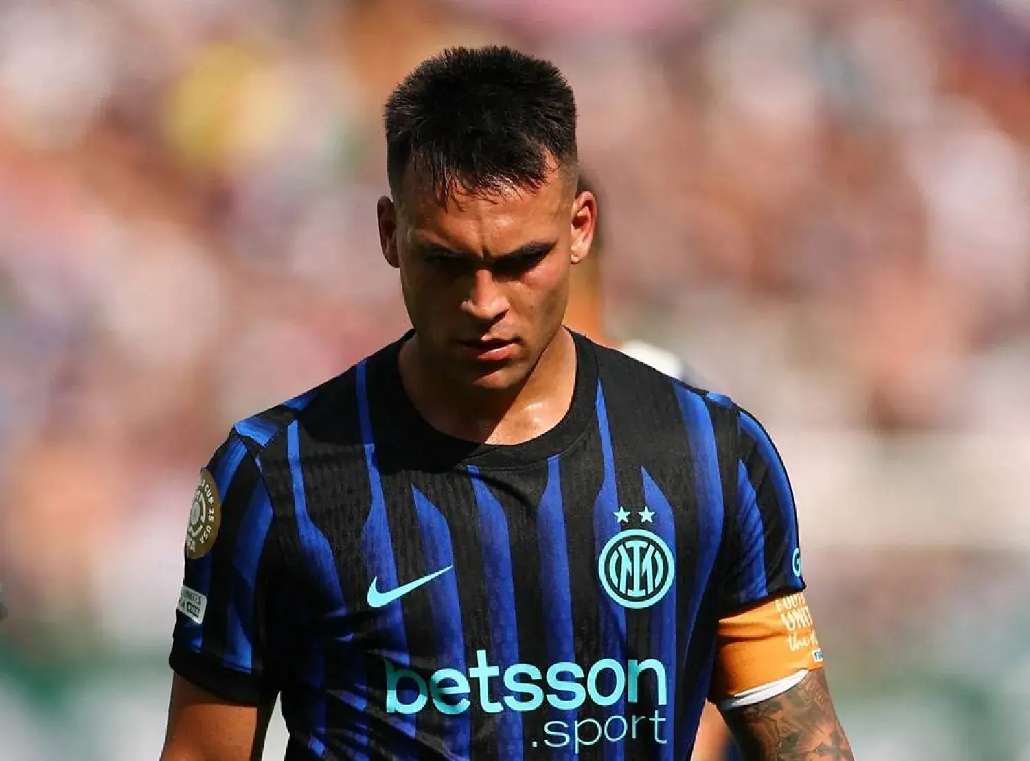 Lautaro Martinez wearing an Inter Milan home jersey with Betsson sponsor logo