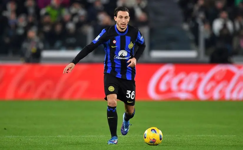 Matteo Darmian in an Inter Milan kit dribbling a soccer ball during a match
