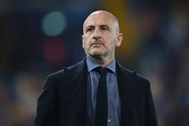 PortraitCandid portrait of Piero Ausilio wearing a dark coat and tie against a blurred stadium background