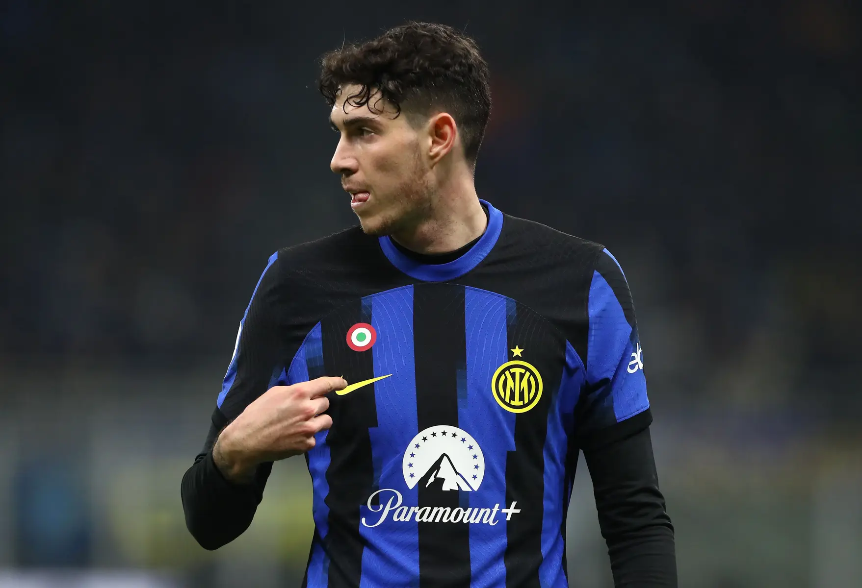 Alessandro Bastoni in an Inter Milan blue and black striped jersey during a football match.