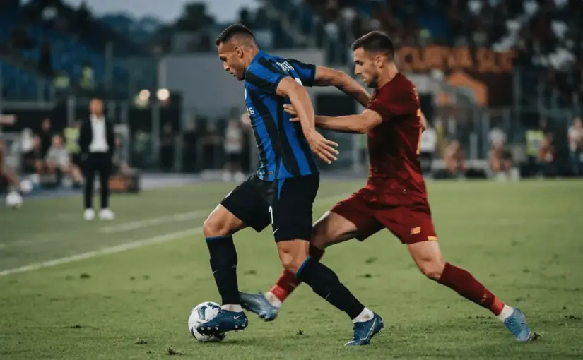 Two anonymous forwards contest the ball during a tense Inter-Roma match duel at the Olimpico.
