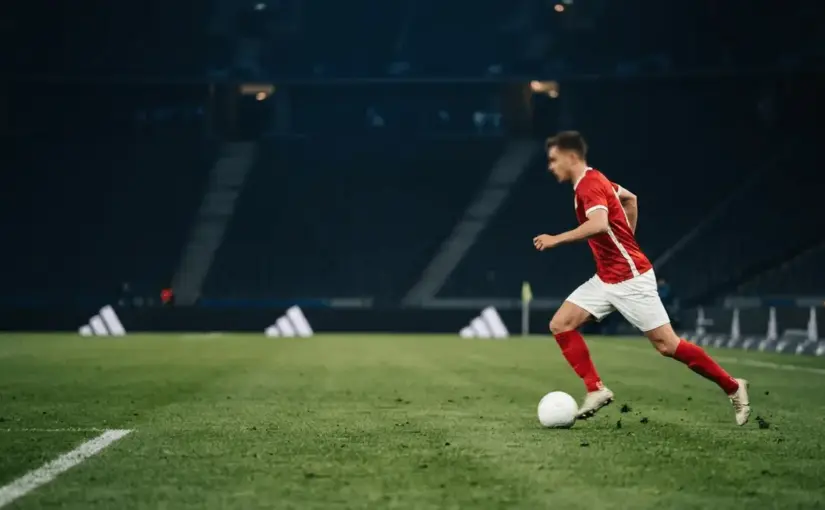 Anonymous winger blocked by a defensive wall in a dramatic football stadium scene